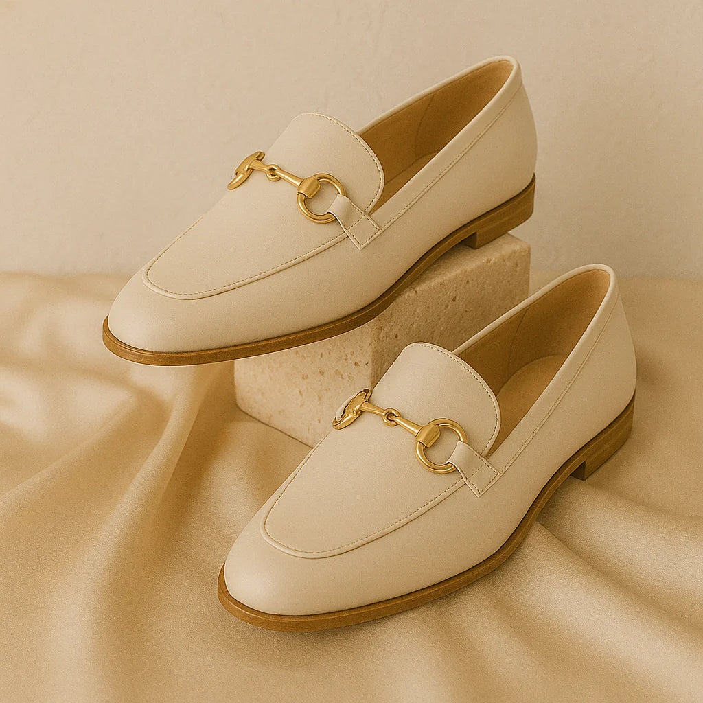 “GlamoROZ Flats & Loafers collection featuring beige leather loafers with gold detailing and classic minimalist flats displayed on neutral fabric.”