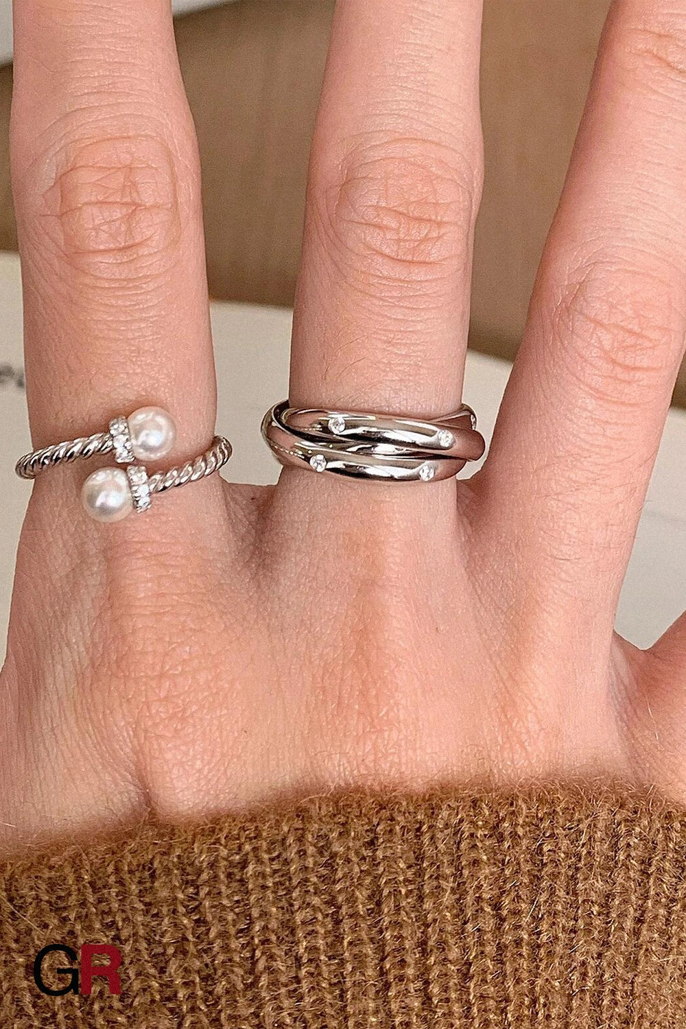 “GlamoROZ Éclat Entrelacé Silver Multi-Layer Trinity Ring Jewelry styled on model hand with minimalist outfit”