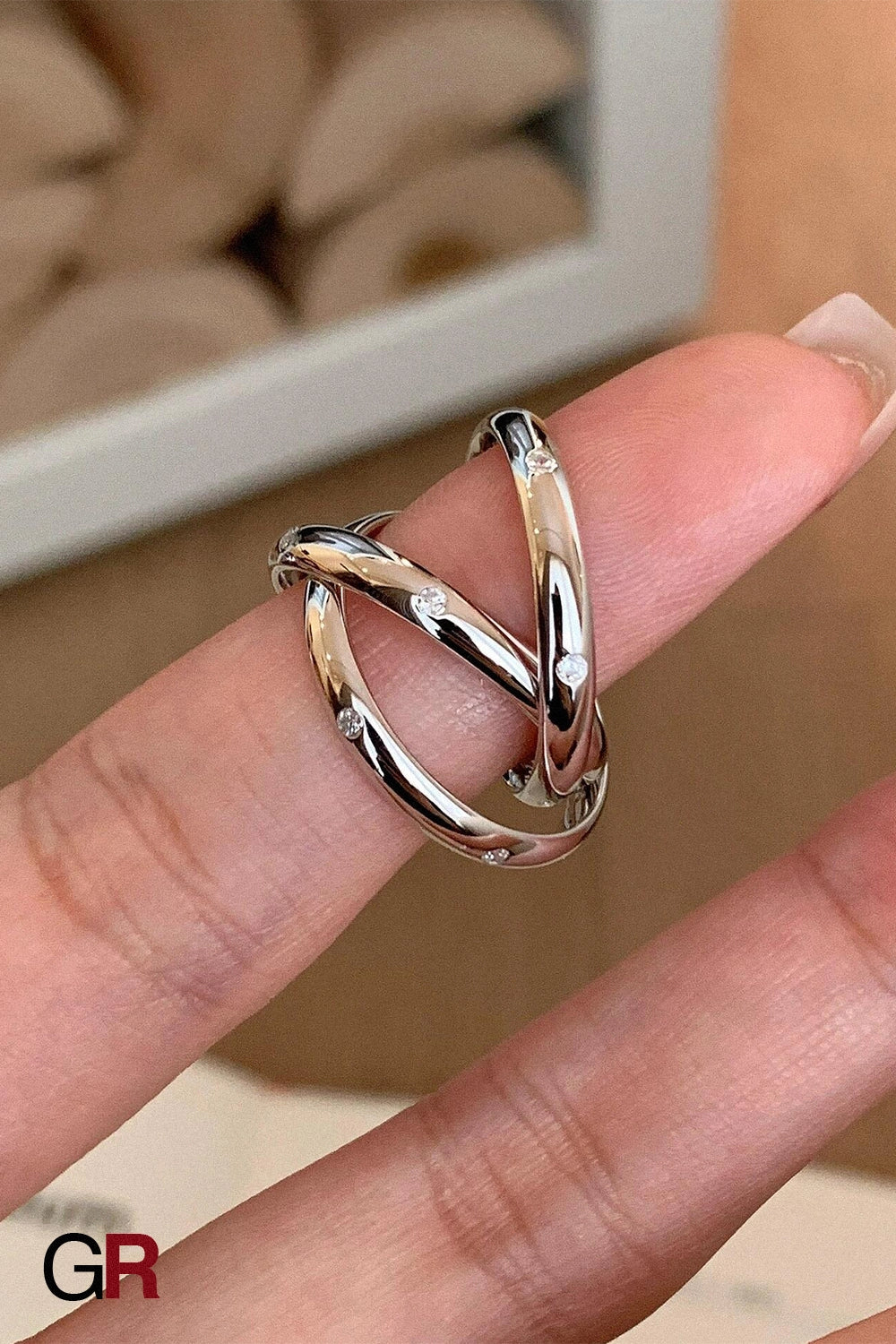 “GlamoROZ Éclat Entrelacé Silver Multi-Layer Trinity Ring Jewelry close-up of intertwined silver bands”