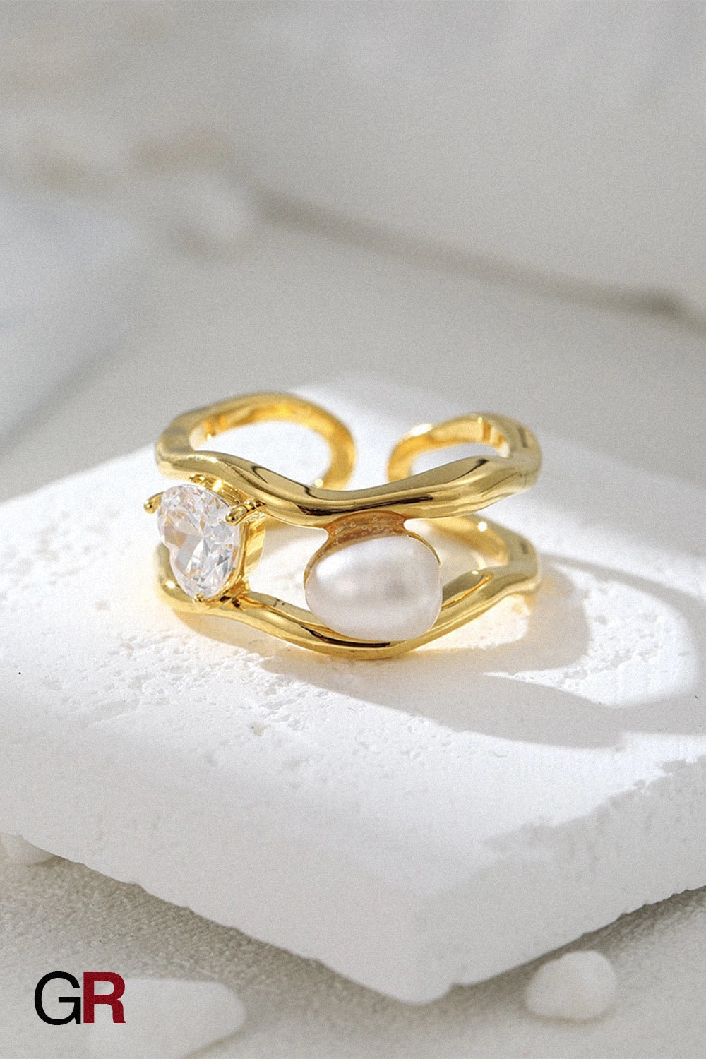 “GlamoROZ Lune Dore Gold & Pearl Ring Jewelry front view on neutral background”