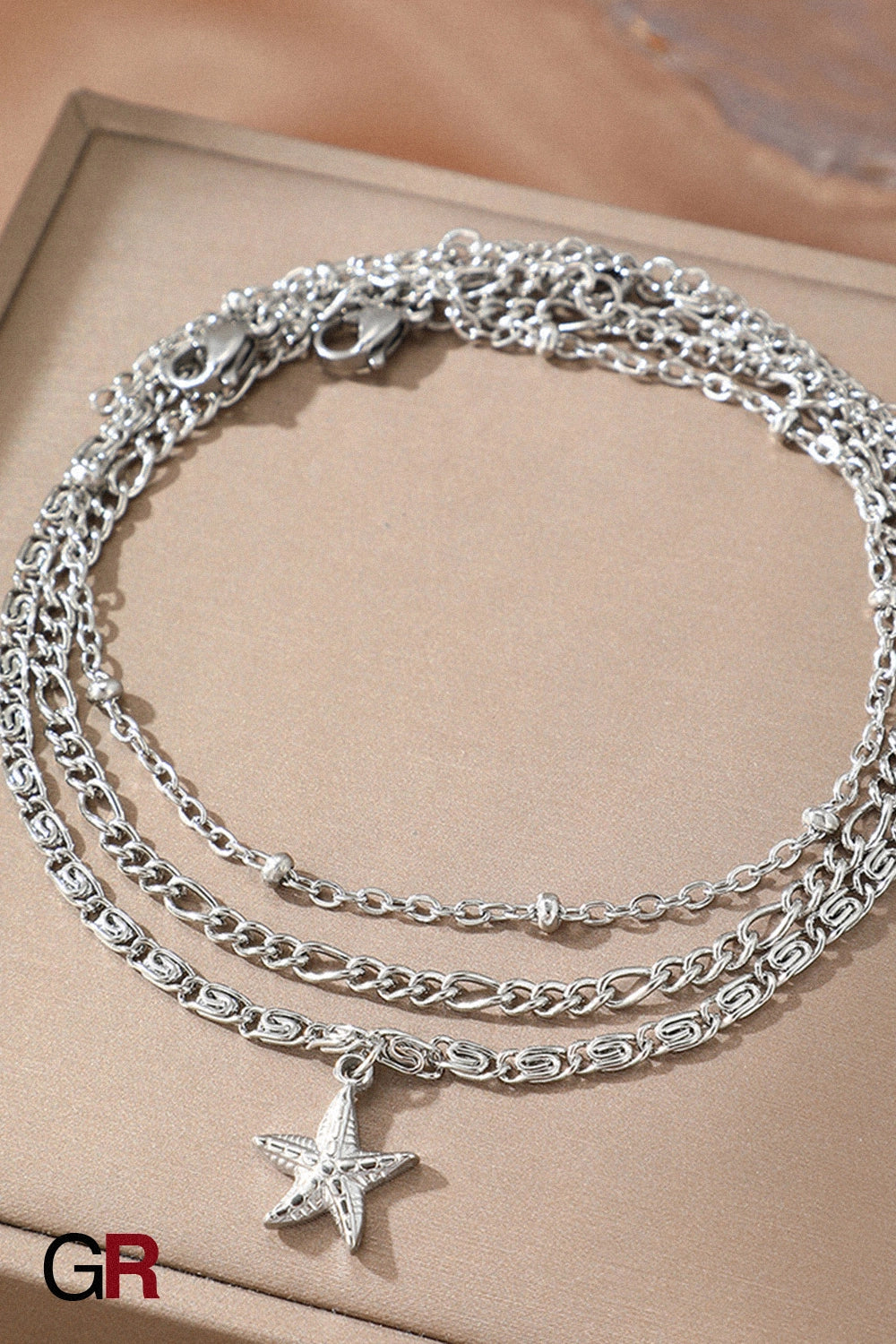 “GlamoROZ Golden Mare Layered Star Anklet styled on model with sandals beach look”