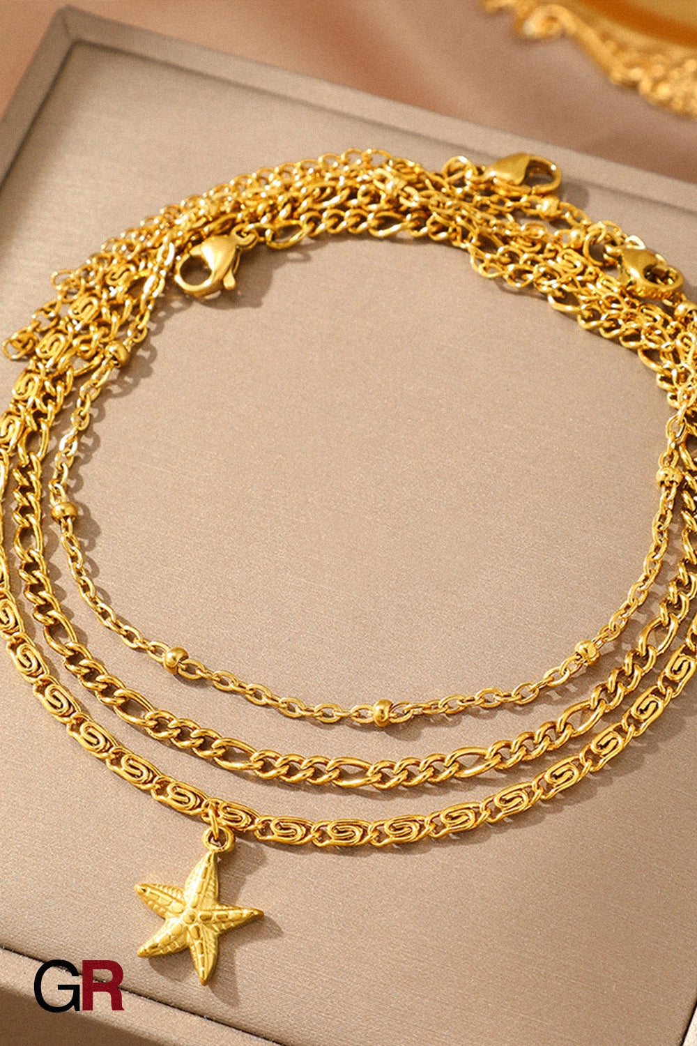 “GlamoROZ Golden Mare Layered Star Anklet front view on neutral background”