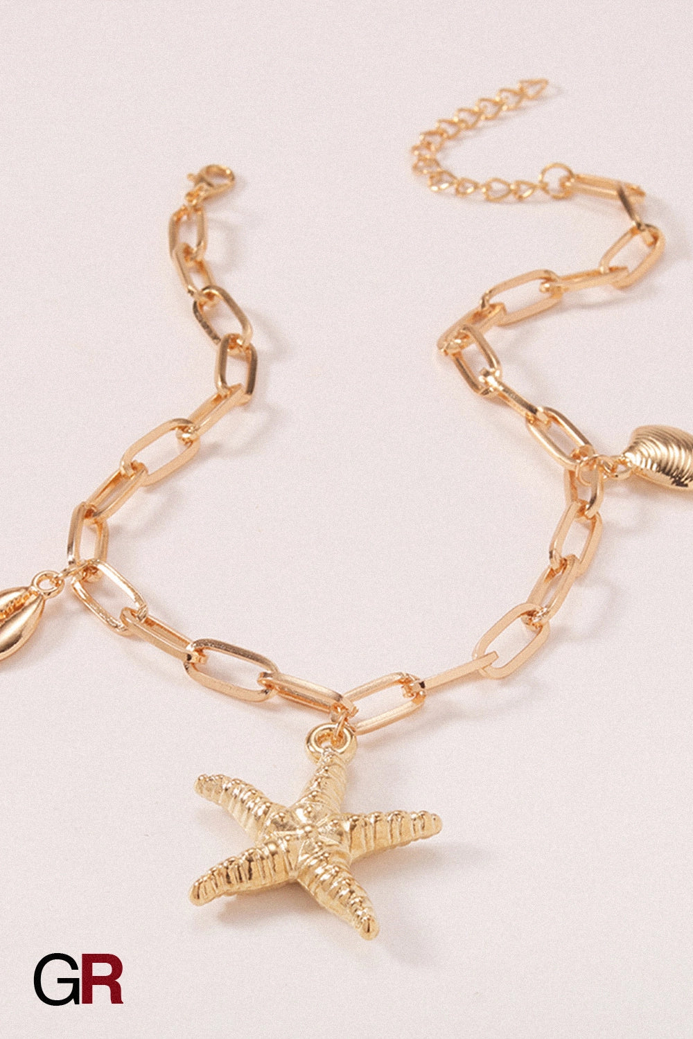 “GlamoROZ Étoile Marine Luminous Starfish Gold Anklet Jewelry styled on model ankle with sandals”