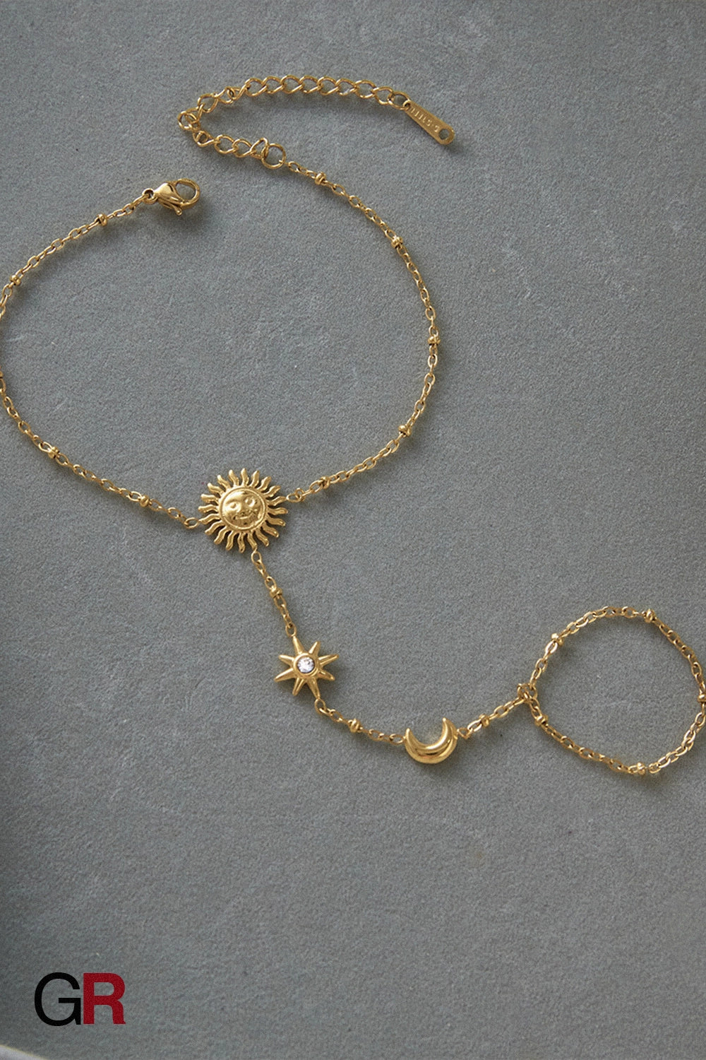 “GlamoROZ Soluna Dorée Luminous Gold Hand Chain Jewelry styled on model hand with sandals”