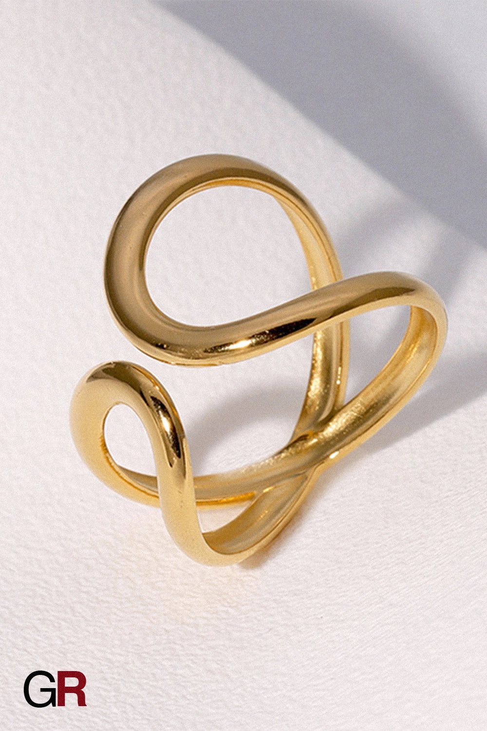 “GlamoROZ Lunaria Flow Gold Open Band Ring Jewelry flat-lay on soft beige fabric background”