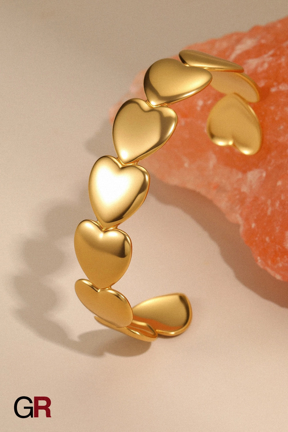 “GlamoROZ Astre Divin Luminous Gold Charm Bangle Jewelry flat-lay on soft beige fabric background”