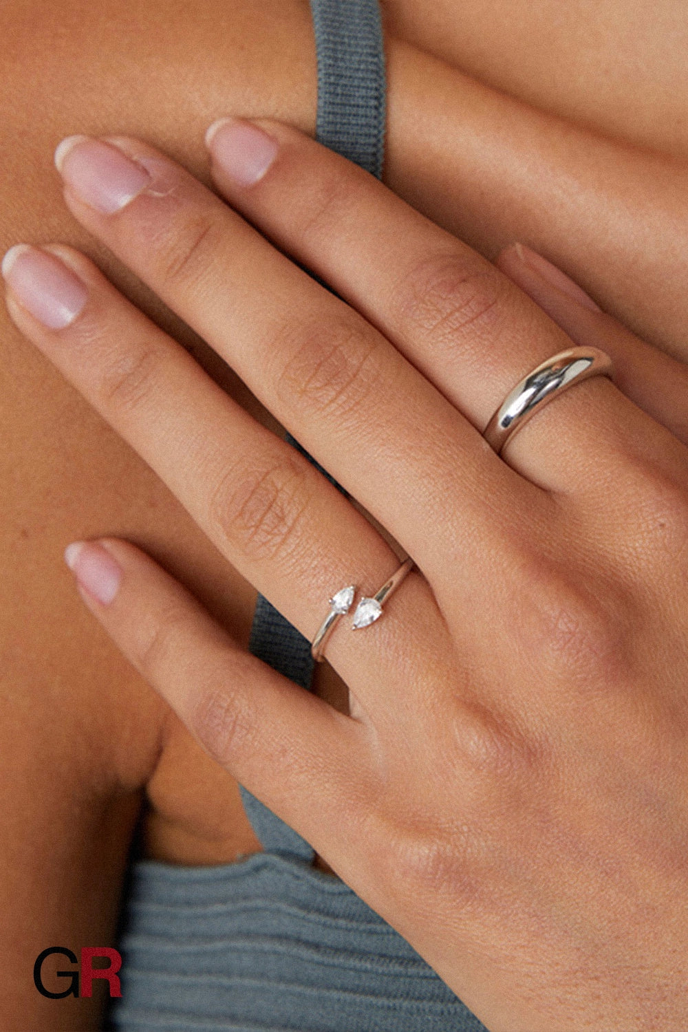 “GlamoROZ Éclat Duo Silver Teardrop Open Band Ring Jewelry flat-lay on soft beige fabric background”