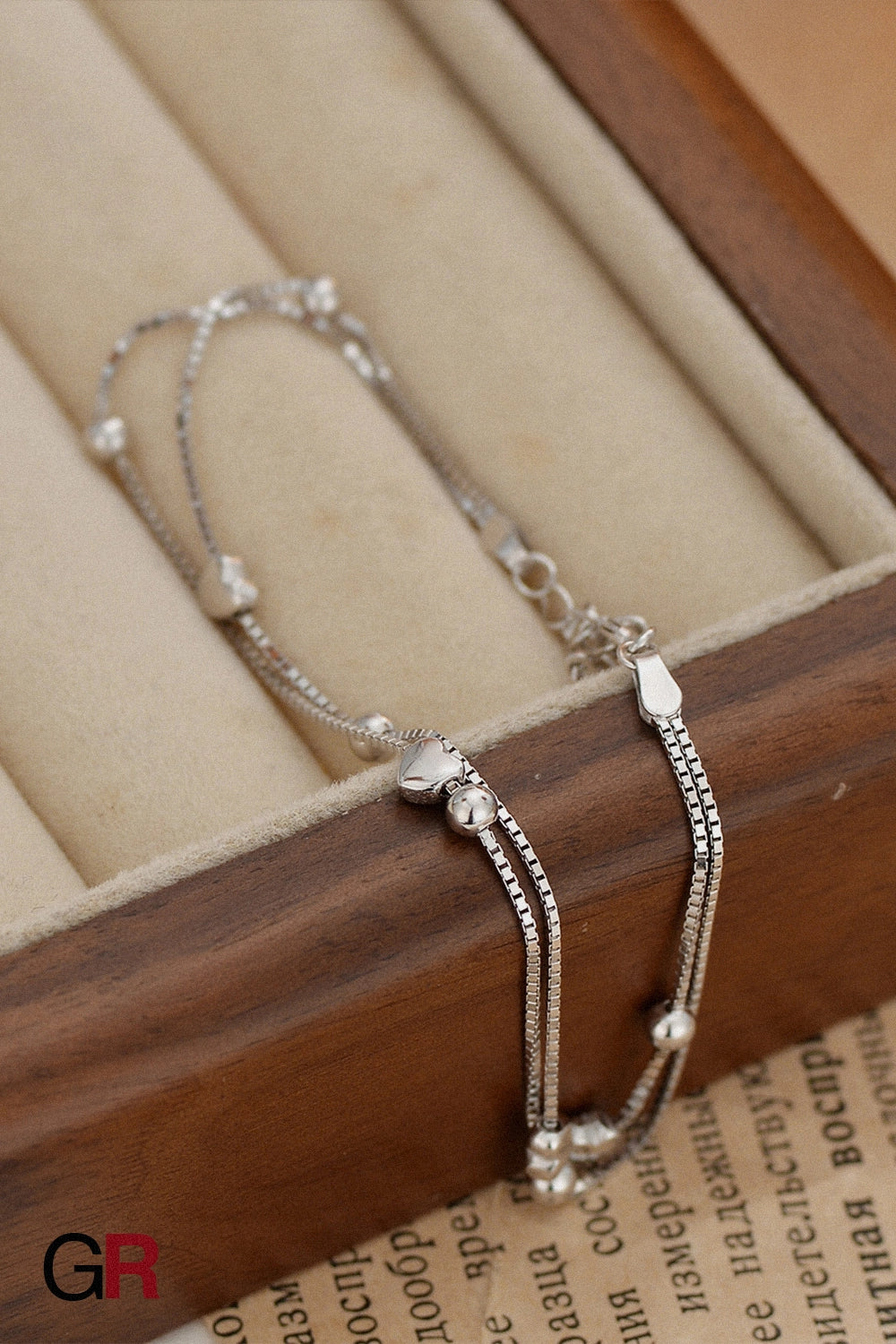 “GlamoROZ Luna Cœur Luminous Gold Beaded Bracelet Jewelry styled on model wrist with sandals”