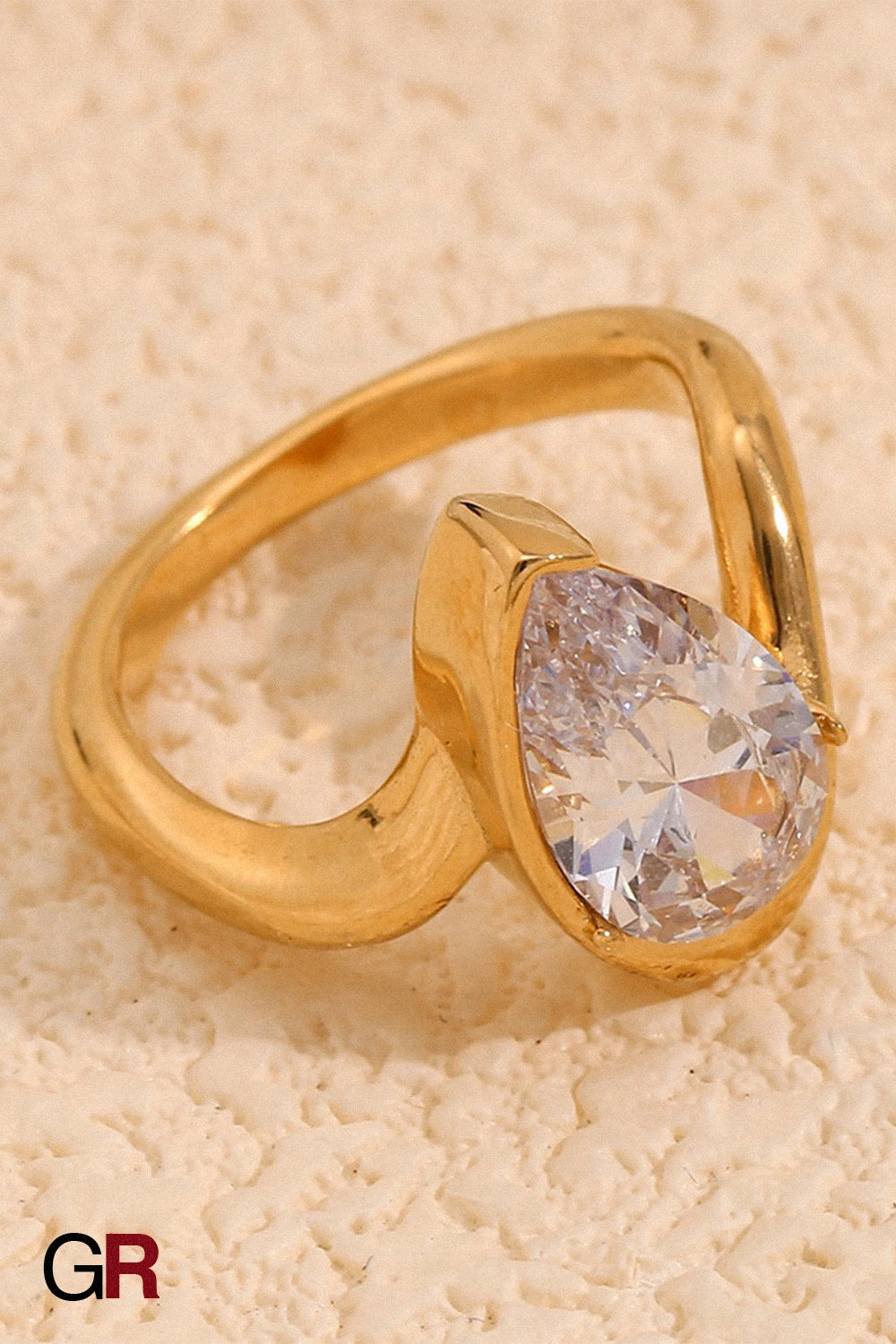 “GlamoROZ Aureole Doré Teardrop Open Band Ring Jewelry front view on neutral background”