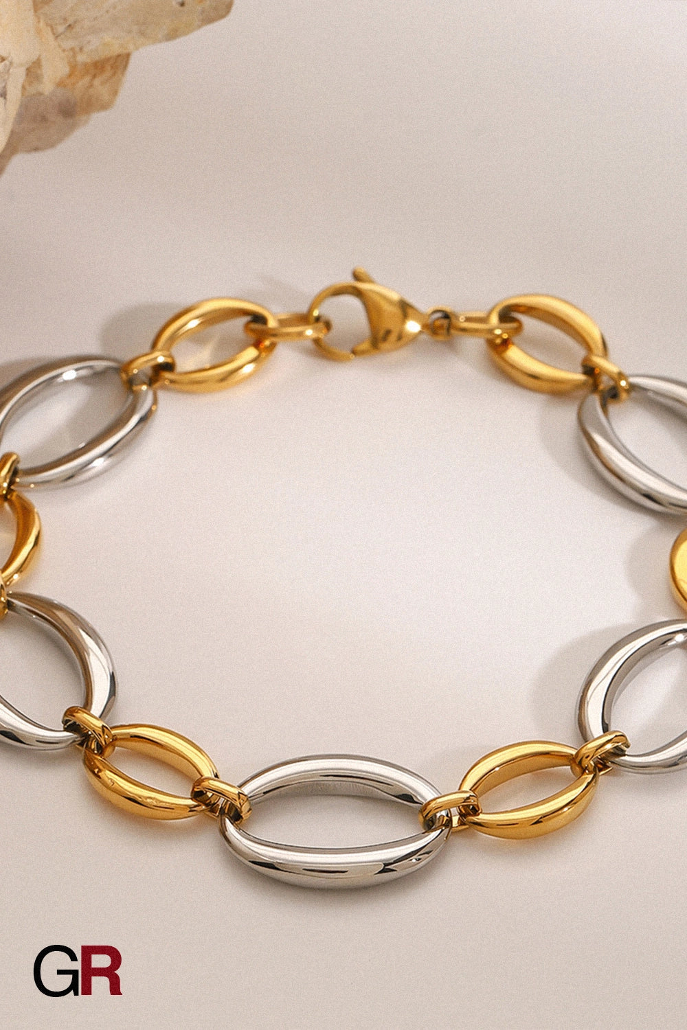 “GlamoROZ Aurora Duo Luminous Link Bracelet Jewelry flat-lay on soft beige fabric background”