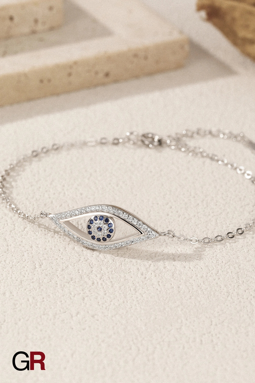 “GlamoROZ Regard Etoile Luminous Silver Eye Charm Bracelet Jewelry close-up of silver eye charm”