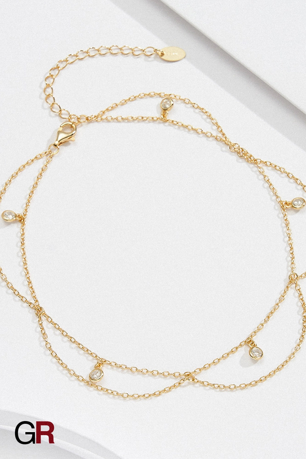 “GlamoROZ Larmes de Mer Luminous Gold Layered Anklet styled on model ankle with sandals”