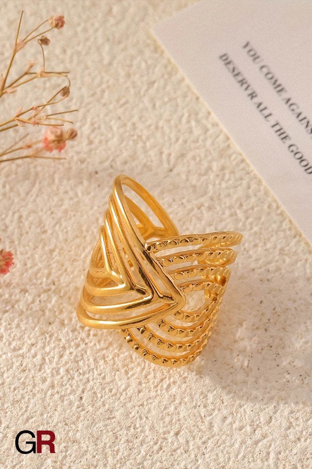 “GlamoROZ Aurum Apex Geometric Ring Jewelry flat-lay on soft beige fabric background”