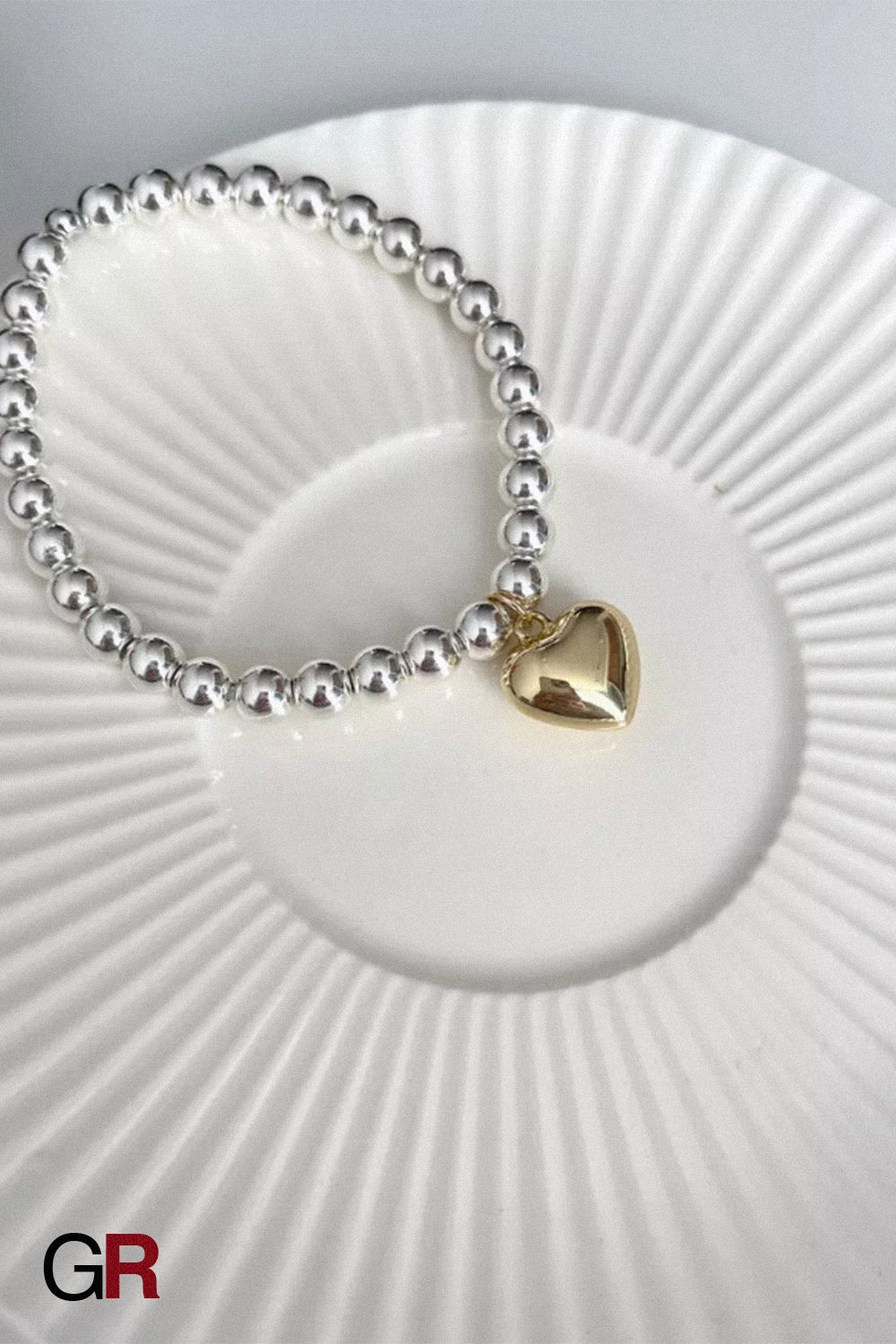 “GlamoROZ Amour Deux Luminous Gold Beaded Bracelet Jewelry close-up of gold beads and heart shapes”