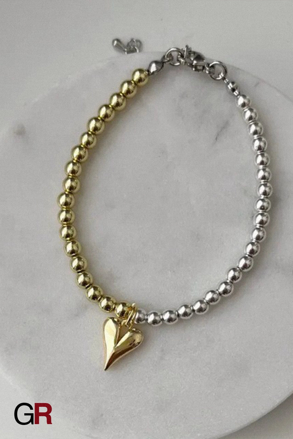 “GlamoROZ Amour Deux Luminous Gold Beaded Bracelet Jewelry flat-lay on soft beige fabric background”