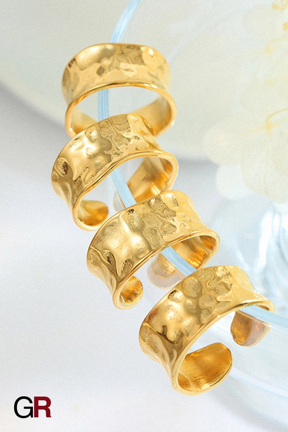 “GlamoROZ Aurora Hammered Gold Band Ring Jewelry styled on model hand with elegant outfit”