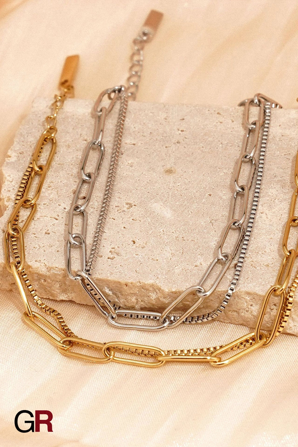 “GlamoROZ Harmonie Duo Luminous Gold Twin Chain Bracelet Jewelry flat-lay on soft beige fabric background”