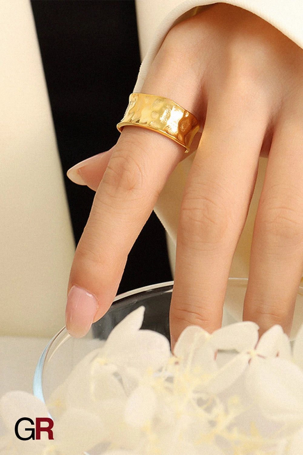 “GlamoROZ Aurora Hammered Gold Band Ring Jewelry flat-lay on soft beige fabric background”