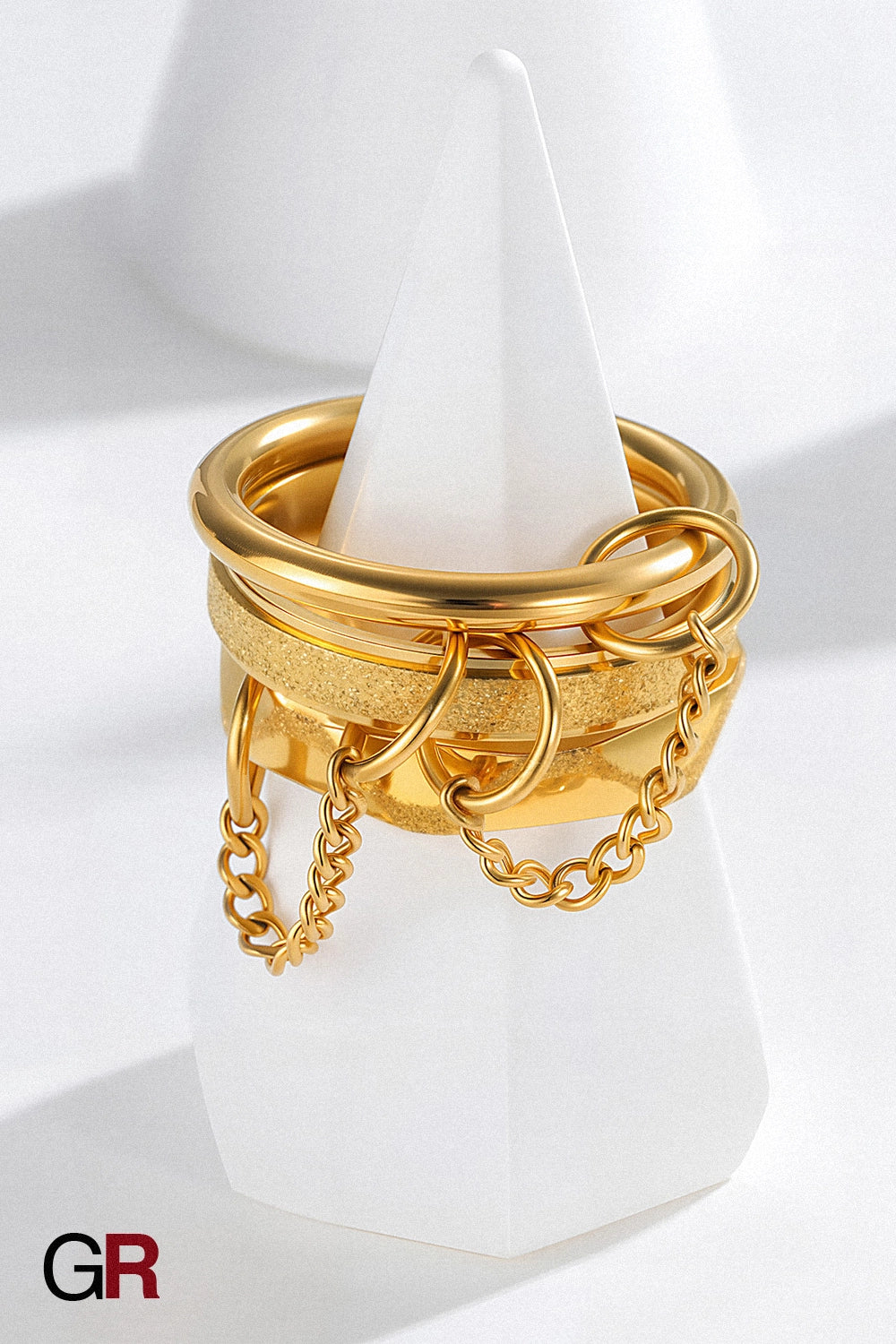 “GlamoROZ Orbit Eclipse Gold & Silver Chain Ring Set Jewelry flat-lay on soft beige fabric background”