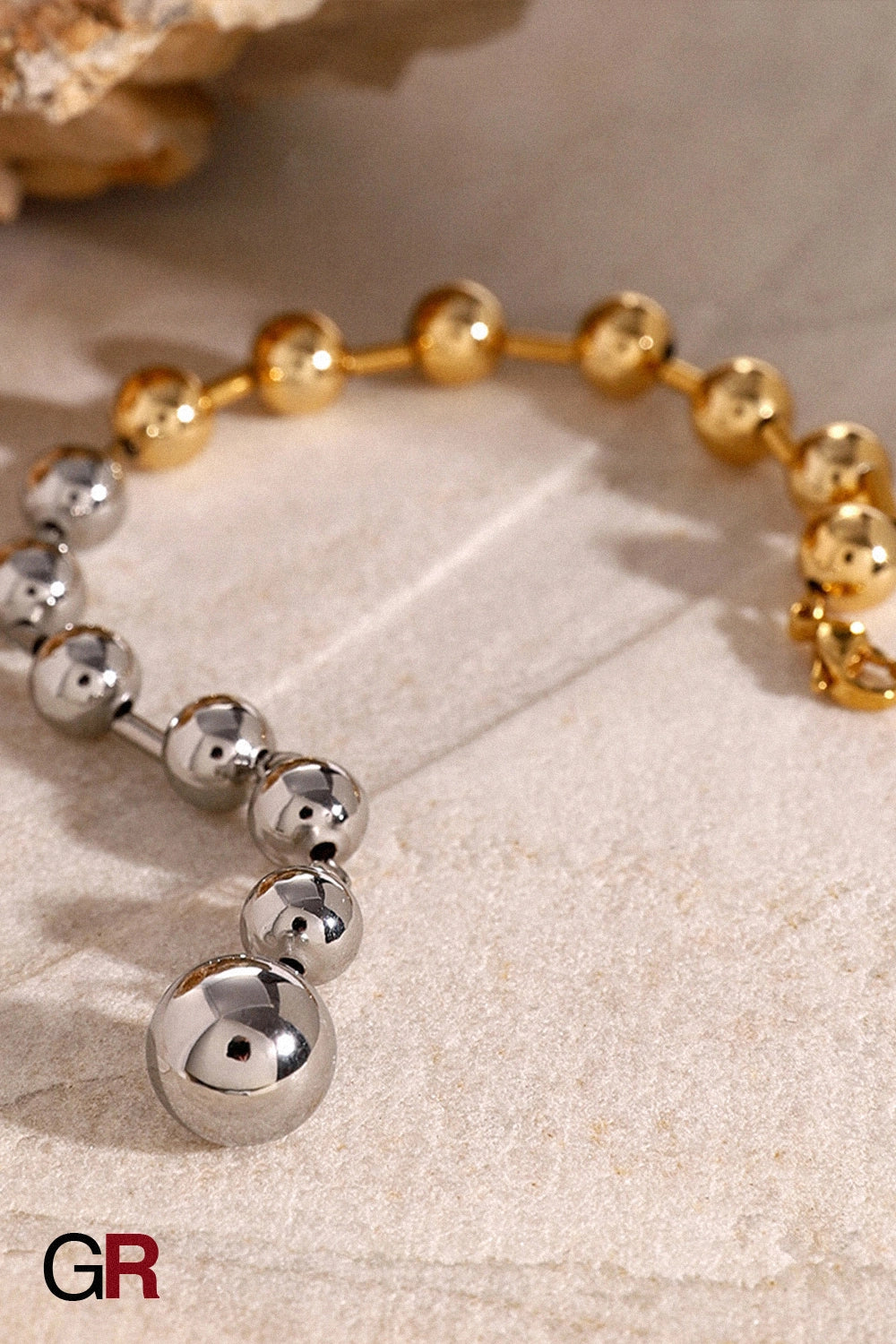 “GlamoROZ Éclat Doré Luminous Gold Bead Bracelet Jewelry styled on model wrist with elegant outfit”